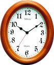 Horloge murale ovale entourage bois teint&eacute; merisier
